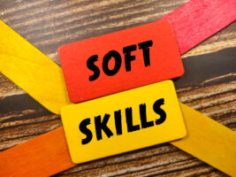 Schriftzug auf Holzplättchen: Soft Skills als Symbolbild für den Ratgeber: Soft Skills und ihre Bedeutung