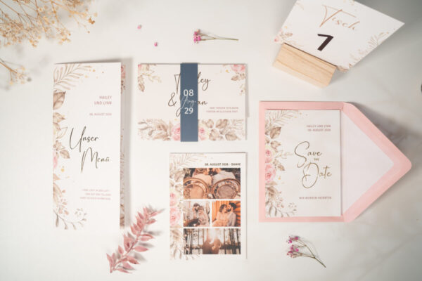 Hochzeitspapeterie im floralen Dusty-Pink-Design mit Save-the-Date, Einladung, Menükarte und Dankeskarte als Flatlay auf hellem Tisch
