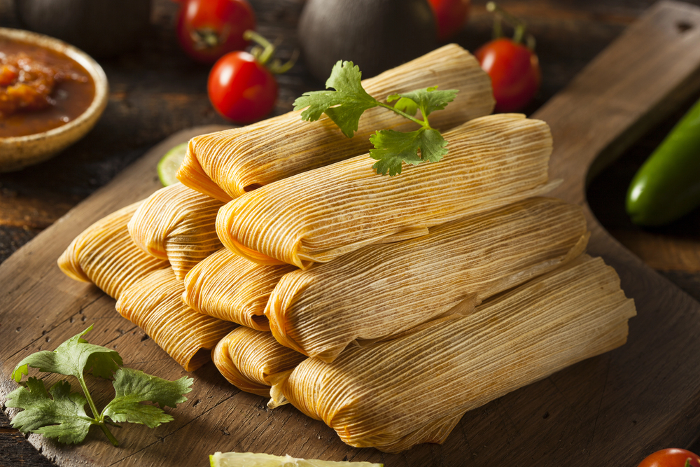 Tamales – Ein traditionelles Weihnachtsessen in Mexiko: Diese herzhaften oder süßen Maisteigpäckchen, eingewickelt in Mais- oder Bananenblätter, werden mit verschiedenen Füllungen wie Fleisch, Käse oder Chilis zubereitet und sind ein festlicher Genuss.