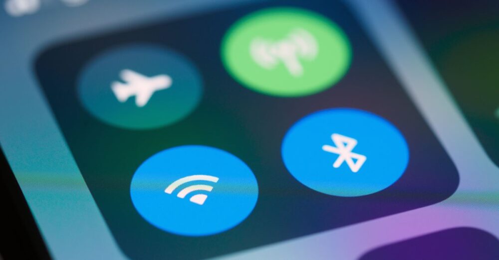 A close-up image showing smartphone control panel with various icons like WiFi and Bluetooth.