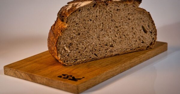 A slice of rustic artisan bread on a wooden board, capturing the essence of traditional baking in a Berlin bakery.