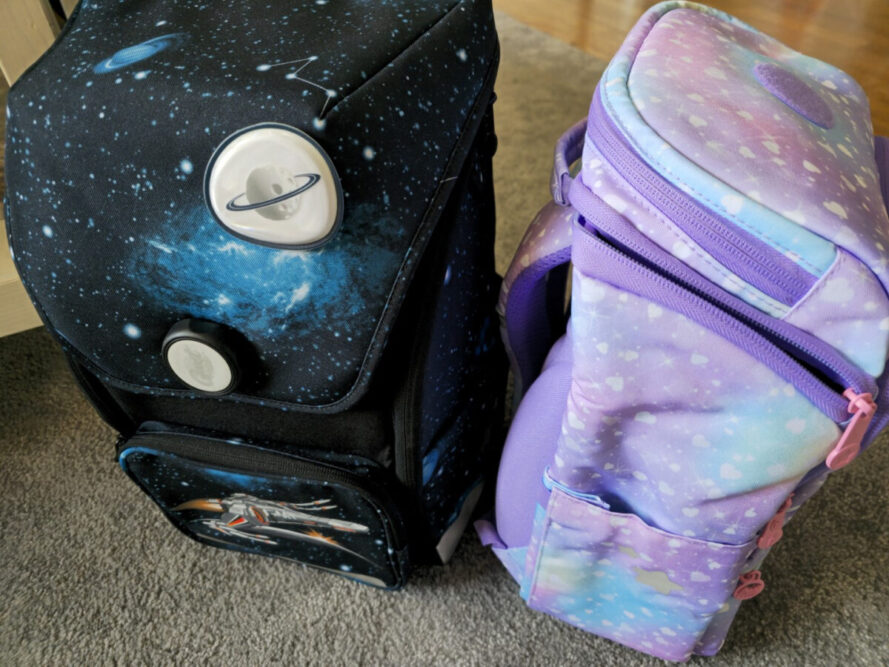 Verschlussvergleich GMT WALL und GMT LIGHT – magnetischer Drehverschluss beim WALL, umlaufender Reißverschluss beim LIGHT