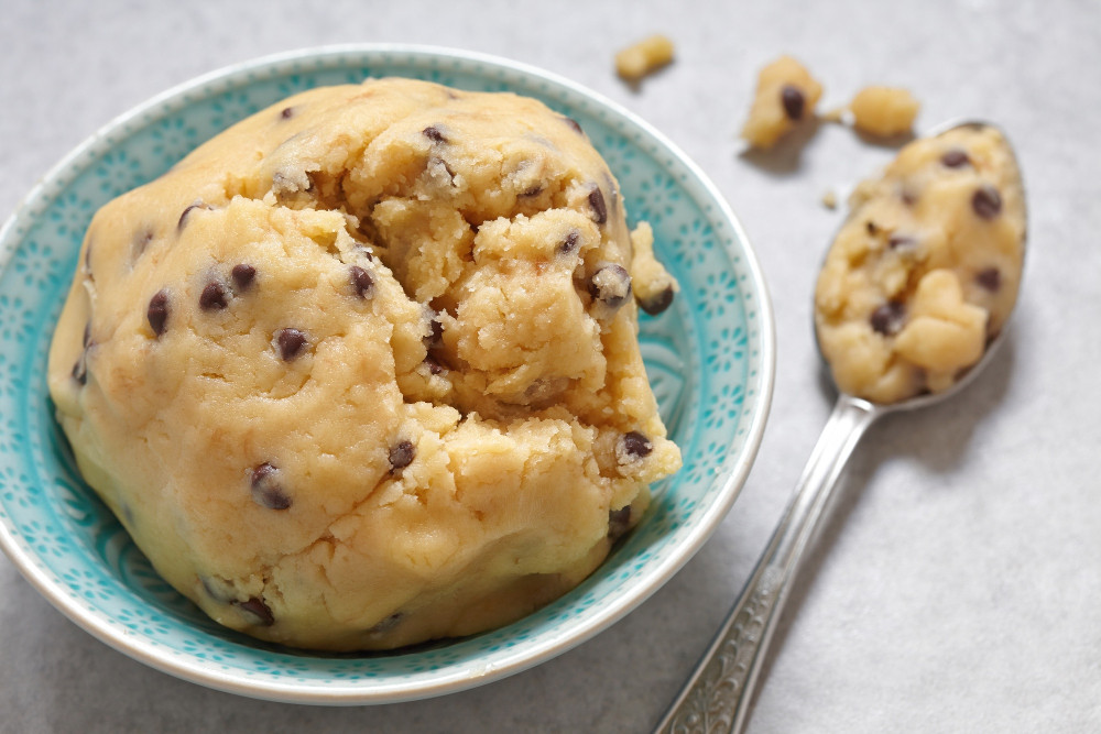 Keksteig zum Löffeln Rezept: cremiger Cookie-Dough mit Schokotropfen in einer Schale, daneben ein Löffel mit Teig.